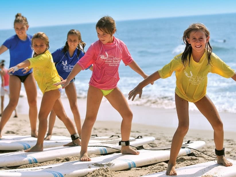 Family friendly surf school with Tony Silvagni in Carolina Beach - Surfboard, bikes and beach gear rentals - North Carolina Cottages vacation rental cottages near Carolina Beach Boardwalk