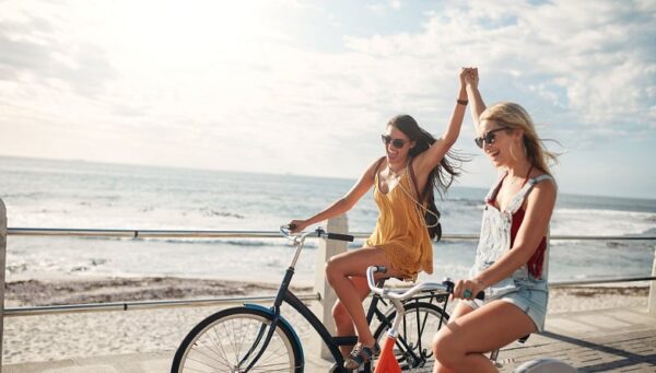 Girls weekend trip at the beach riding bicycles in Carolina Beach and Kure Beach, NC - Plan your next girls trip to Carolina Beach