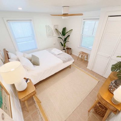 The cozy design of the bedroom with warm lighting, plush bedding, and comfortable furniture creates a welcoming atmosphere that invites you to relax and unwind after a long day